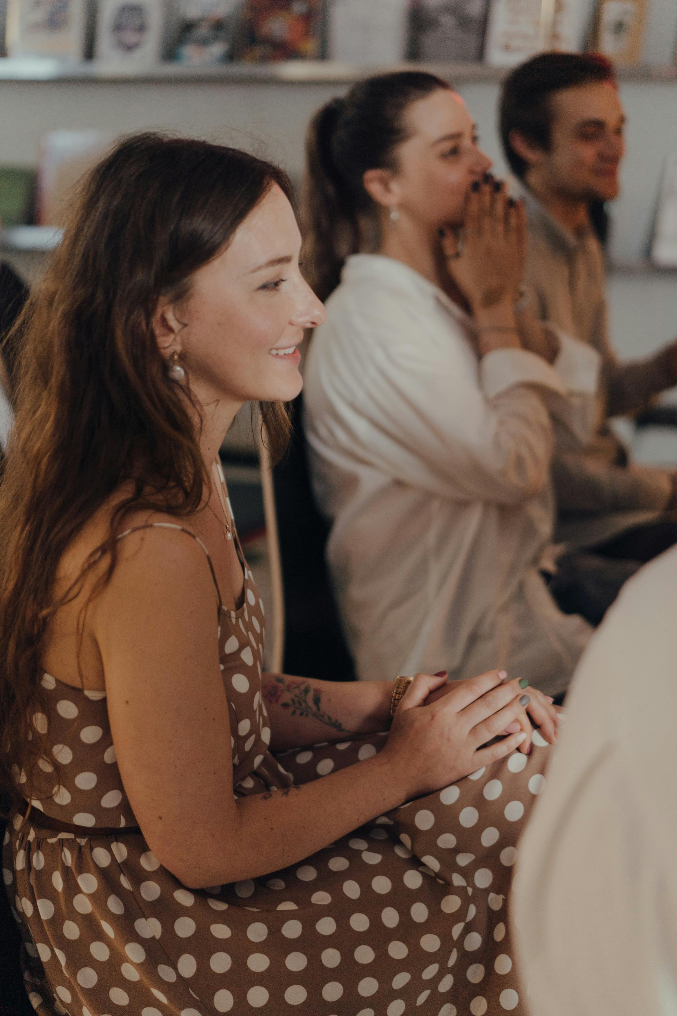 Attendees enjoying a creative discussion indoors with a lively atmosphere.